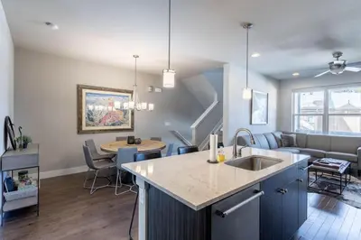 a kitchen and living room with a sink and a couch at Winter Park 3BR Townhouse with Mountain views in Fraser