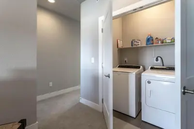 a kitchen with a washer and dryer and a sink at Winter Park 3BR Townhouse with Mountain views in Fraser