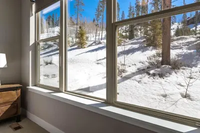 a window with a view of a snow covered field at Winter Park 3BR Townhouse with Mountain views in Fraser