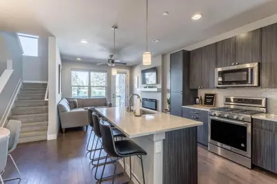 a kitchen with a counter and a kitchen island with chairs at Winter Park 3BR Townhouse with Mountain views in Fraser
