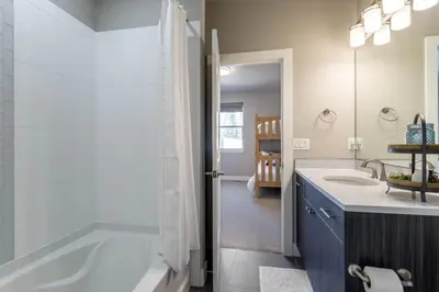a bathroom with a tub and a sink at Winter Park 3BR Townhouse with Mountain views in Fraser