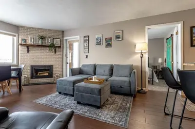 a living room with a couch and a fireplace at Ski in ski out condo in Granby in Granby