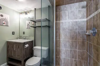 a bathroom with a toilet and a glass shower at Ski in ski out condo in Granby in Granby