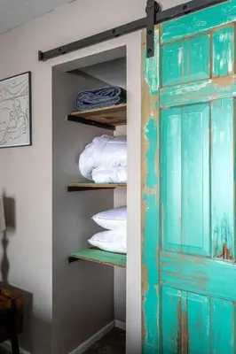 an open door in a room with towels on shelves at Ski in ski out condo in Granby in Granby