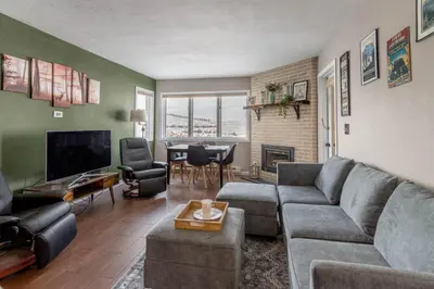 a living room with a couch and a tv at Ski in ski out condo in Granby in Granby