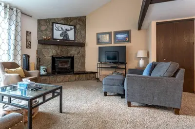 a living room with a couch and a fireplace at Fraser 3BR Condo with Pool and Hot Tub in Fraser