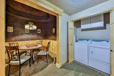 a kitchen with a table and a laundry room at Rocky Mountain High - Pet Friendly in Grand Lake
