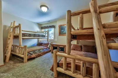 a bedroom with two bunk beds in a lodge at Rocky Mountain High - Pet Friendly in Grand Lake