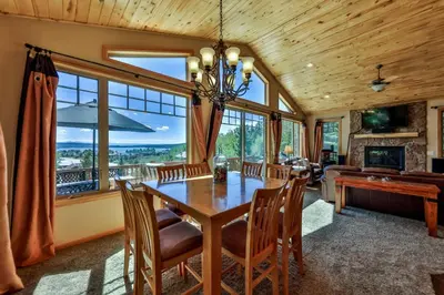 a dining room with a table and a piano at Rocky Mountain High - Pet Friendly in Grand Lake