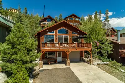 a large house with a deck on a mountain at Rocky Mountain High - Pet Friendly in Grand Lake