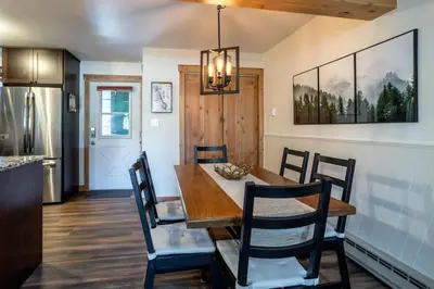 a kitchen and dining room with a wooden table and chairs at WP Top Floor Getaway in Winter Park