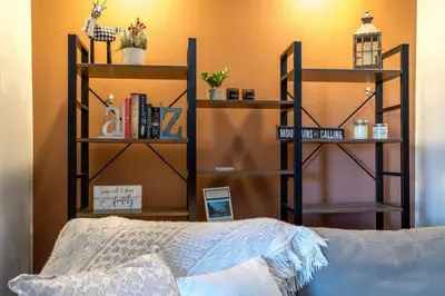 a room with a bed and shelves with books at WP Top Floor Getaway in Winter Park