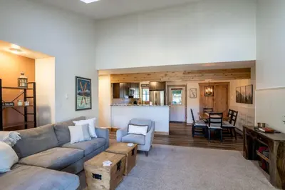 a living room with a couch and a table at WP Top Floor Getaway in Winter Park