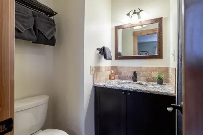 a bathroom with a sink and a mirror at WP Top Floor Getaway in Winter Park