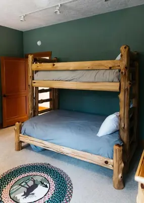 a bedroom with two bunk beds and a rug at Scenic Mountain Retreat in Fraser in Granby