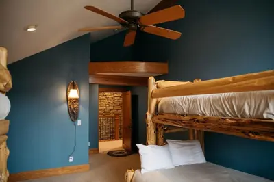 a bedroom with two bunk beds and a ceiling fan at Scenic Mountain Retreat in Fraser in Granby