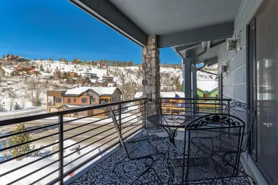 a balcony with a view of a snowy mountain at Love Grand Lake Townhouse Pet Friendly With garage in Grand Lake