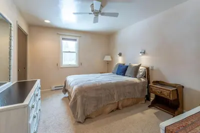 a bedroom with a bed and a ceiling fan at Winter Park Condo with Fireplace and Mountain Views in Winter Park