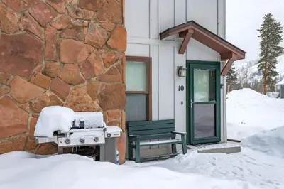 a grill outside of a building in the snow at Winter Park Condo with Fireplace and Mountain Views in Winter Park