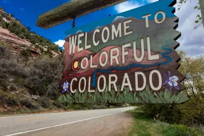 a sign for the welcome to colombolis colombia at Winter Park Condo with Fireplace and Mountain Views in Winter Park