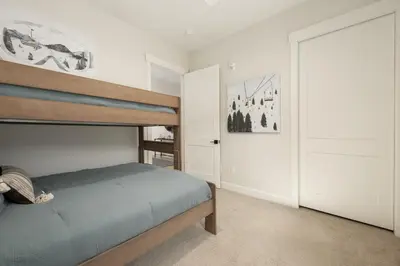 a bedroom with a bunk bed and a bedroom backdoor at Cozy Grand Lake Hideaway Walk to Lake and Restaurants in Grand Lake