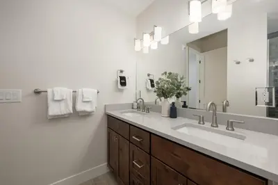 a bathroom with two sinks and a large mirror at Cozy Grand Lake Hideaway Walk to Lake and Restaurants in Grand Lake