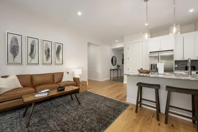 a living room with a couch and a kitchen at Cozy Grand Lake Hideaway Walk to Lake and Restaurants in Grand Lake
