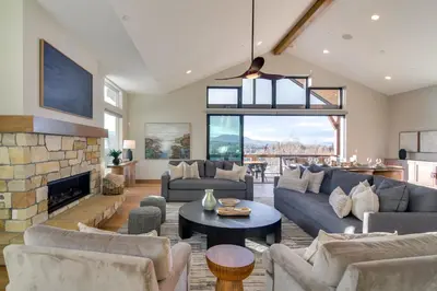 a living room with couches and a fireplace at Luxe Home with Hot Tub, Close to Winter Park Resort! in Fraser
