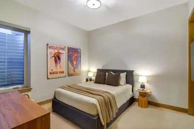 a bedroom with a king sized bed and a window at Luxe Home with Hot Tub, Close to Winter Park Resort! in Fraser