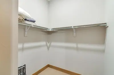 a room with white walls and white shelves at Luxe Home with Hot Tub, Close to Winter Park Resort! in Fraser