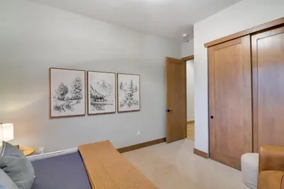 a living room with four framed drawings on the wall at Luxe Home with Hot Tub, Close to Winter Park Resort! in Fraser