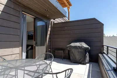 a patio with a table and chairs and a tent at Mad Moose Retreat Gorgeous Condo by Grand Lake in Grand Lake