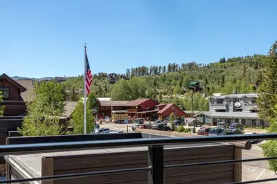 a view from a balcony of a town with a flag at Mad Moose Retreat Gorgeous Condo by Grand Lake in Grand Lake