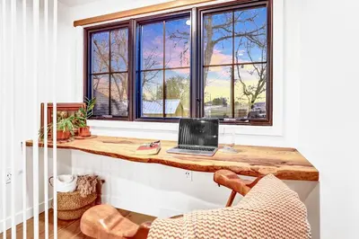 a room with a desk with a laptop on a window at Peaceful Ranch Overlooking Mustangs with Full Kitchen & Fireplace in Longmont