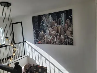a painting of a city on the wall of a staircase at Denver Layover B&B in DEN