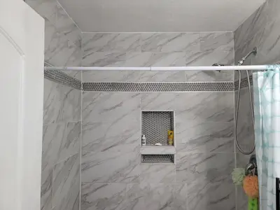 a bathroom with a shower with a sink at Denver Layover B&B in DEN