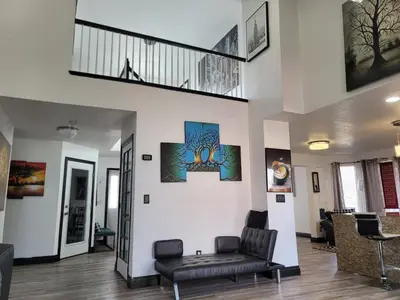 a living room with a couch and a staircase at Denver Layover B&B in DEN