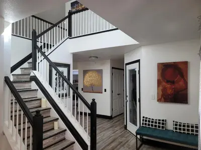 a staircase in a home with white walls at Denver Layover B&B in DEN