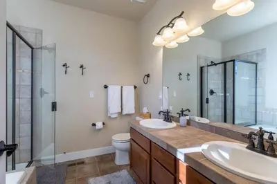 a bathroom with two sinks and a shower and a toilet at 3 BR Private Mountain Retreat in Granby