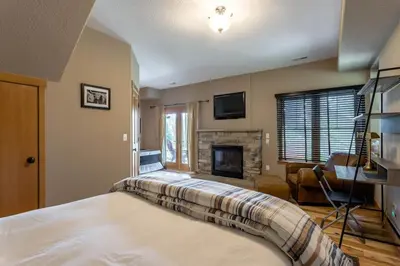 a bedroom with a bed and a fireplace at Luxury Getaway in Winter Park Fraser in Granby