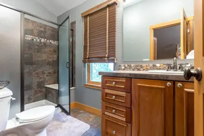 a bathroom with a toilet and a sink and a shower at Luxury Getaway in Winter Park Fraser in Granby