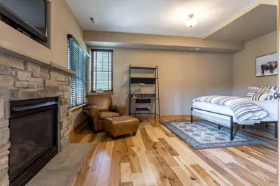 a living room with a fireplace and a tv at Luxury Getaway in Winter Park Fraser in Granby