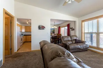 a living room with a couch and a kitchen at Central and Cozy Townhouse in Fraser