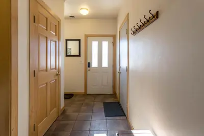 a hallway with a door and a tile floor at Central and Cozy Townhouse in Fraser