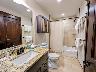 a bathroom with a sink and a toilet and a tub at River Run Townhomes 73 by SummitCove Lodging in Keystone