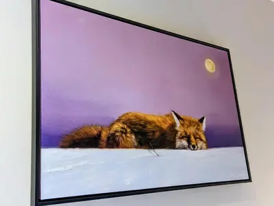a picture of a wolf laying in the snow at River Run Townhomes 73 by SummitCove Lodging in Keystone