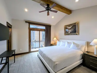 a bedroom with a bed and a ceiling fan at River Run Townhomes 73 by SummitCove Lodging in Keystone