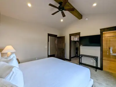 a bedroom with a white bed and a ceiling fan at River Run Townhomes 73 by SummitCove Lodging in Keystone