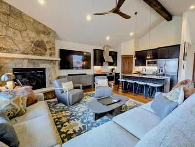 a living room with a couch and a fireplace at River Run Townhomes 73 by SummitCove Lodging in Keystone
