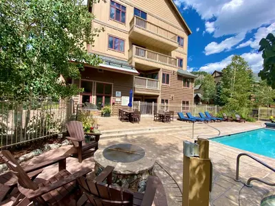 a patio with a table and chairs and a pool at Red Hawk Lodge 2242 by SummitCove Lodging in Keystone
